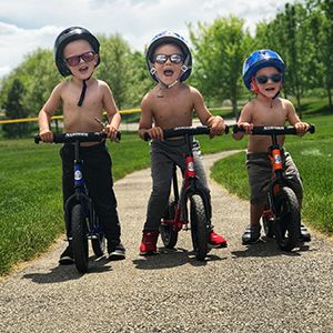 A group of boys pose while on their Strider Bikes