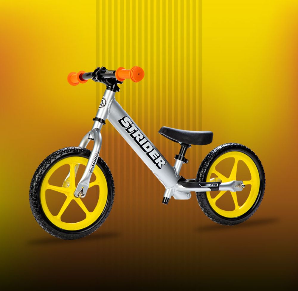 Studio Image of silver Pro with yellow Ultralight Wheels, and an aluminum flat bar with orange grips
