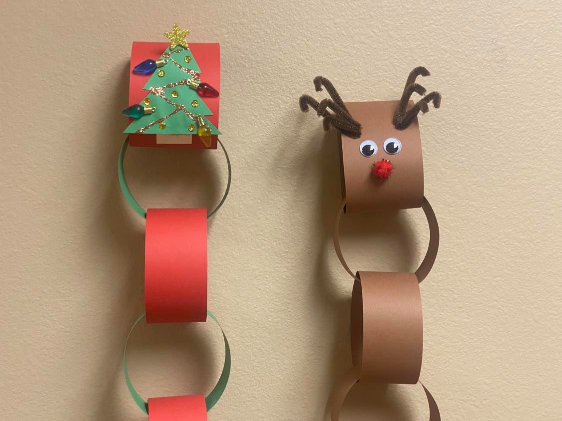 Holiday countdown chains with a Christmas tree and a reindeer on top
