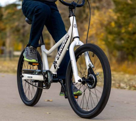 A rider pedaling the Strider 20x Sport, a 20" all-in-one balance and pedal bike