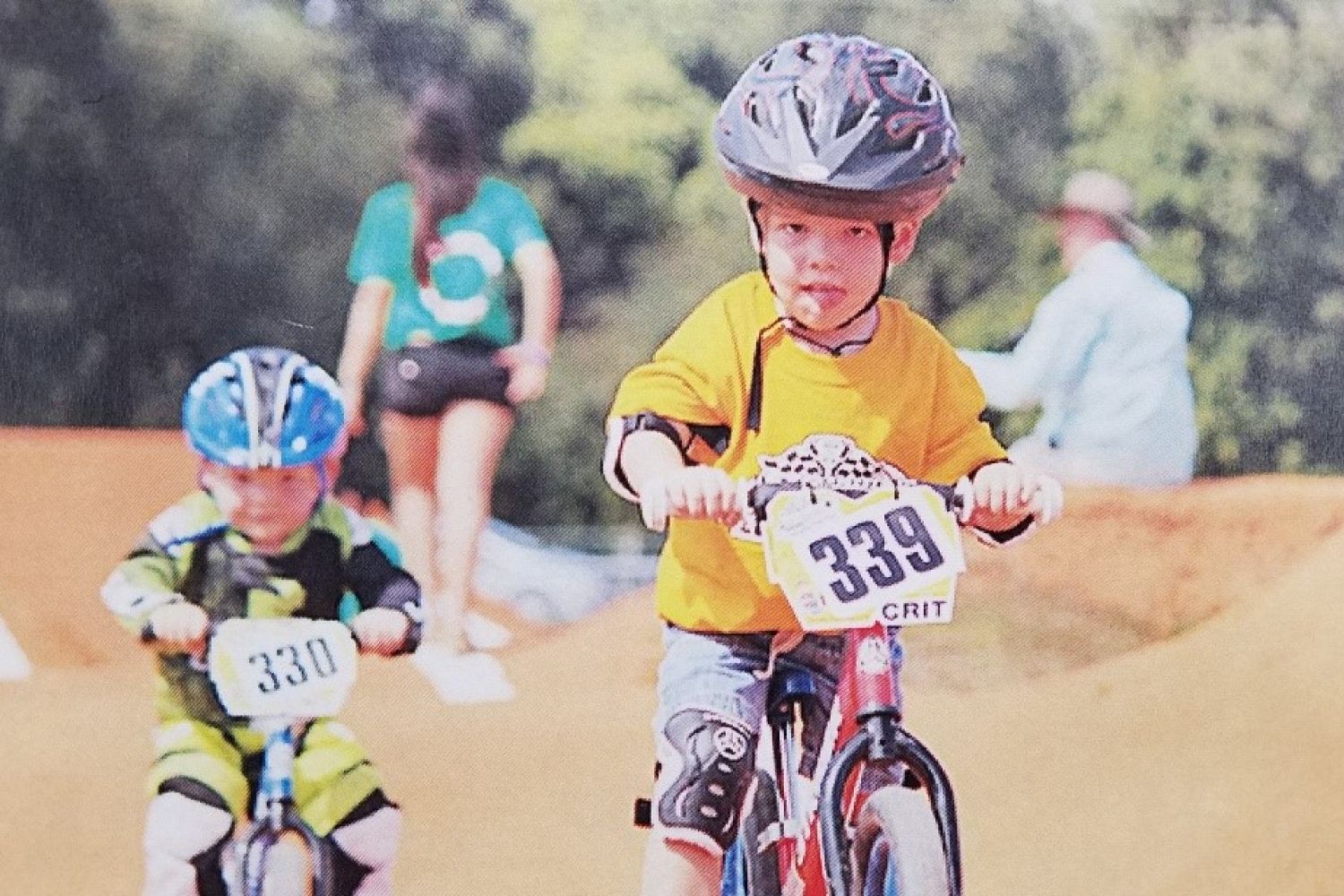 Young boy riding red 12 Classic in Strider Cup race