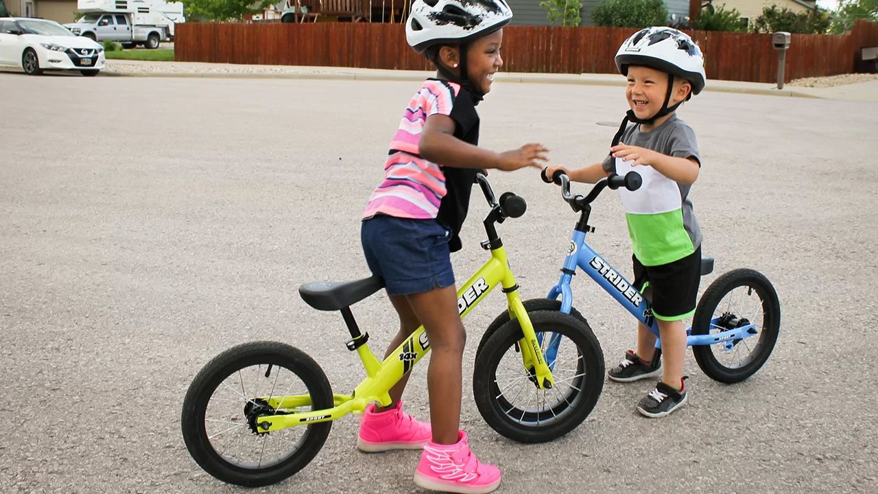 Boy and girl giggling on Strider 14x bikes