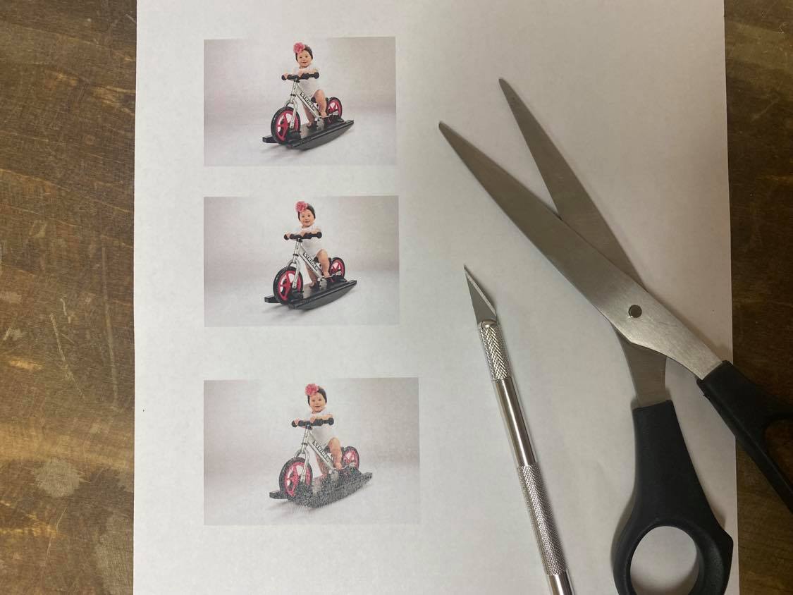 Cutting out a photo of a baby on a Rocking bike 